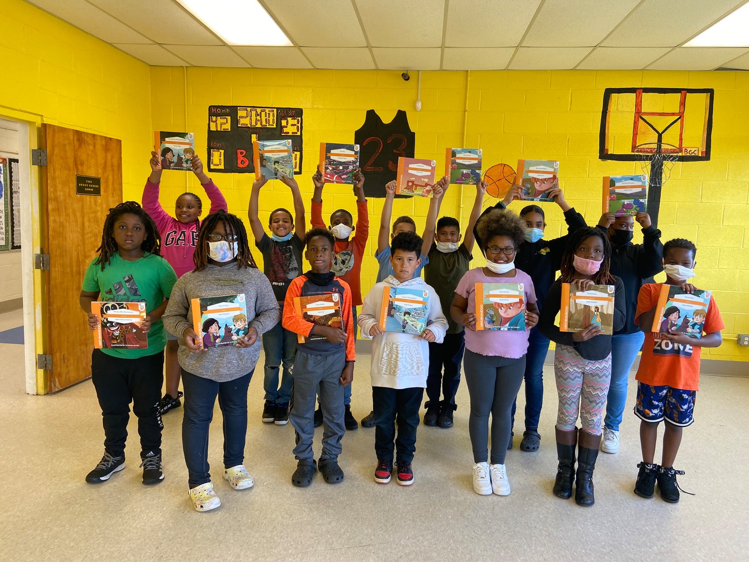 Some of the 40 or so participants in a program last summer at the Boys & Girls Club in Siler City hold up the books they authored.
